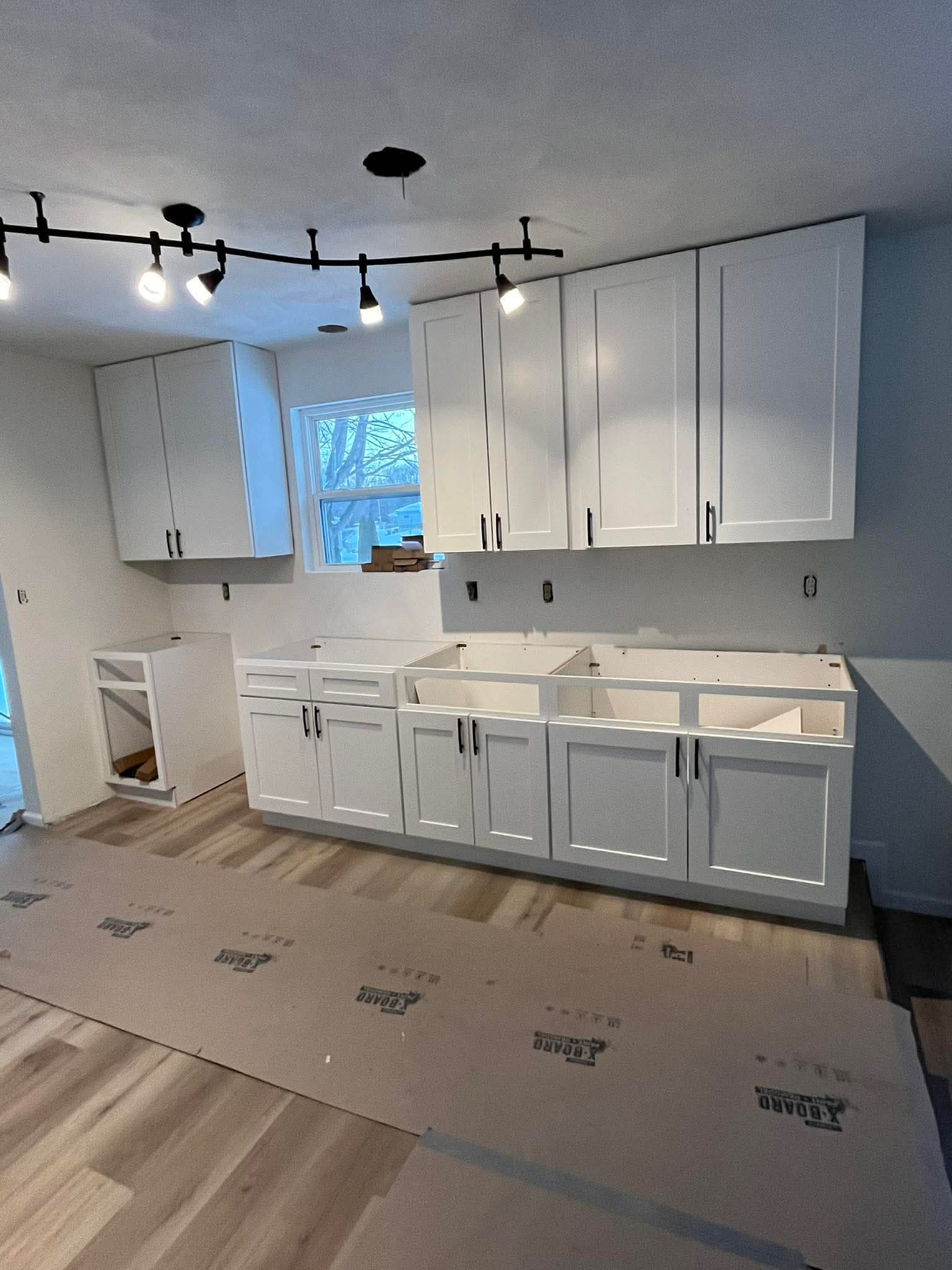 Full kitchen remodel with white shaker cabinets and track lighting by Frame to Finish Construction in Belleville IL